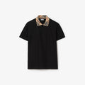 polo noir à col à carreaux est une pièce classique de la maison de luxe britannique Burberry