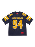 maillot Supreme Sequin Football Jersey de couleur bleu marine avec des numéros dorés